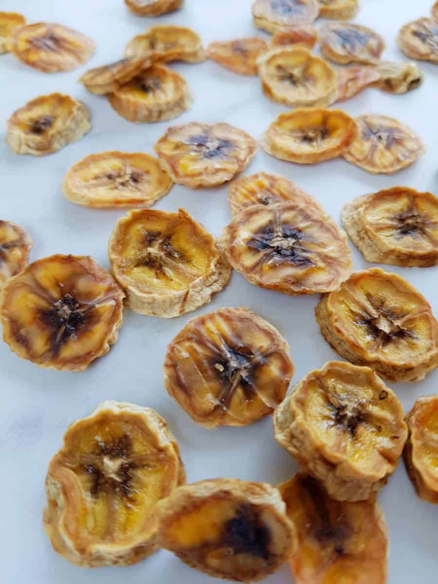 Banana chips on a marble table.