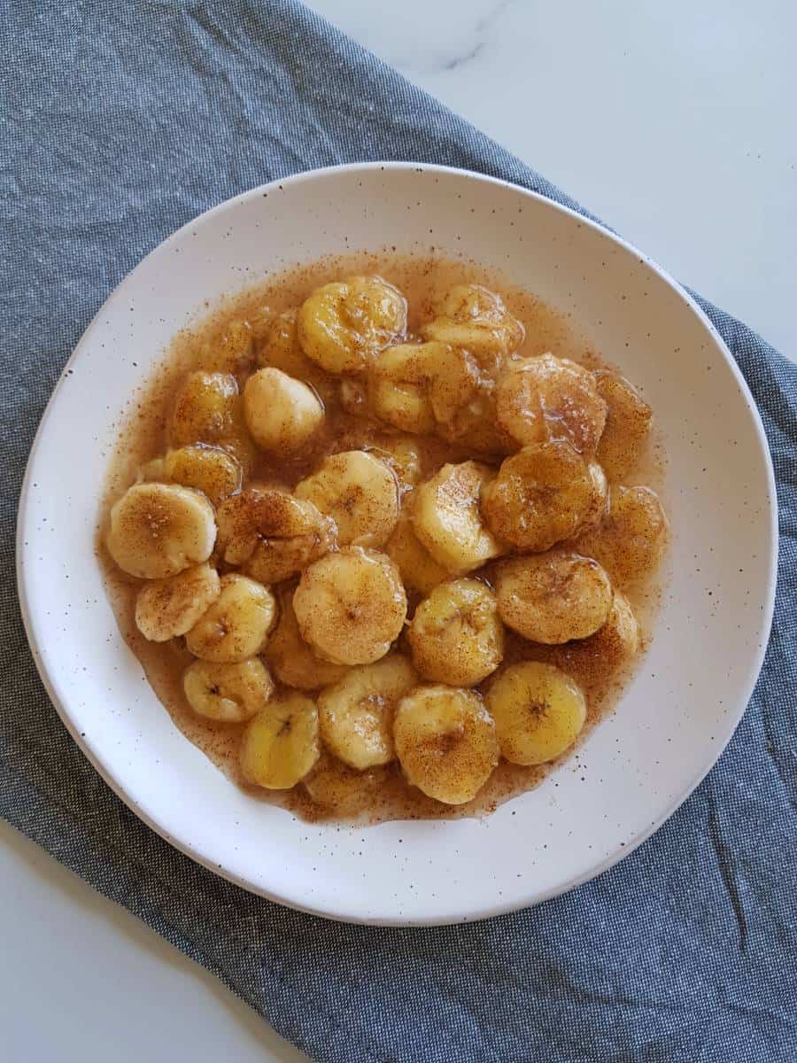 Banana churros on a white plate.