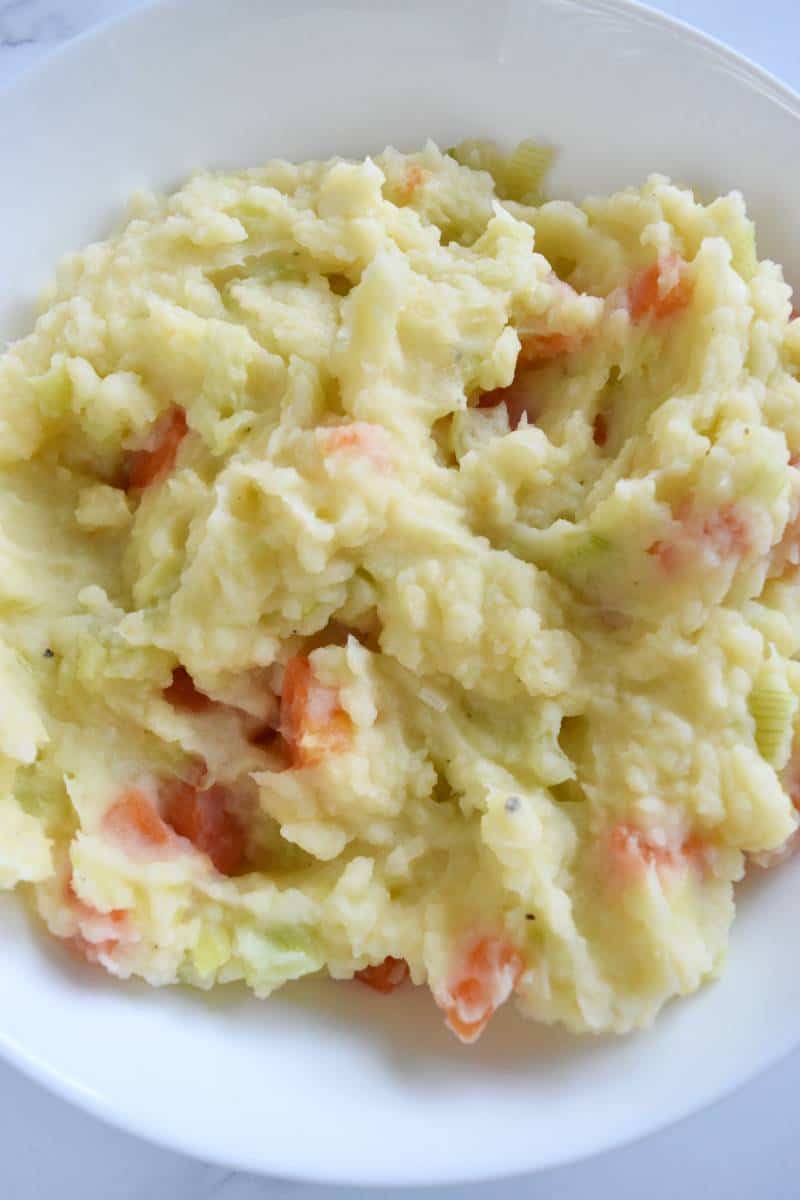 Belgian mashed potatoes with carrots in a bowl.