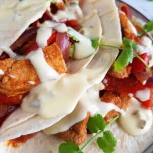 Cheesy tex mex sour cream sauce on fajitas.