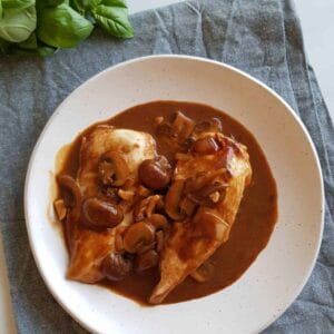 Chicken marsala on a white plate.