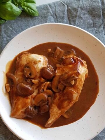 Chicken marsala on a white plate.