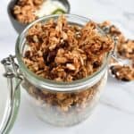 Granola with cinnamon and raisins in a mason jar.