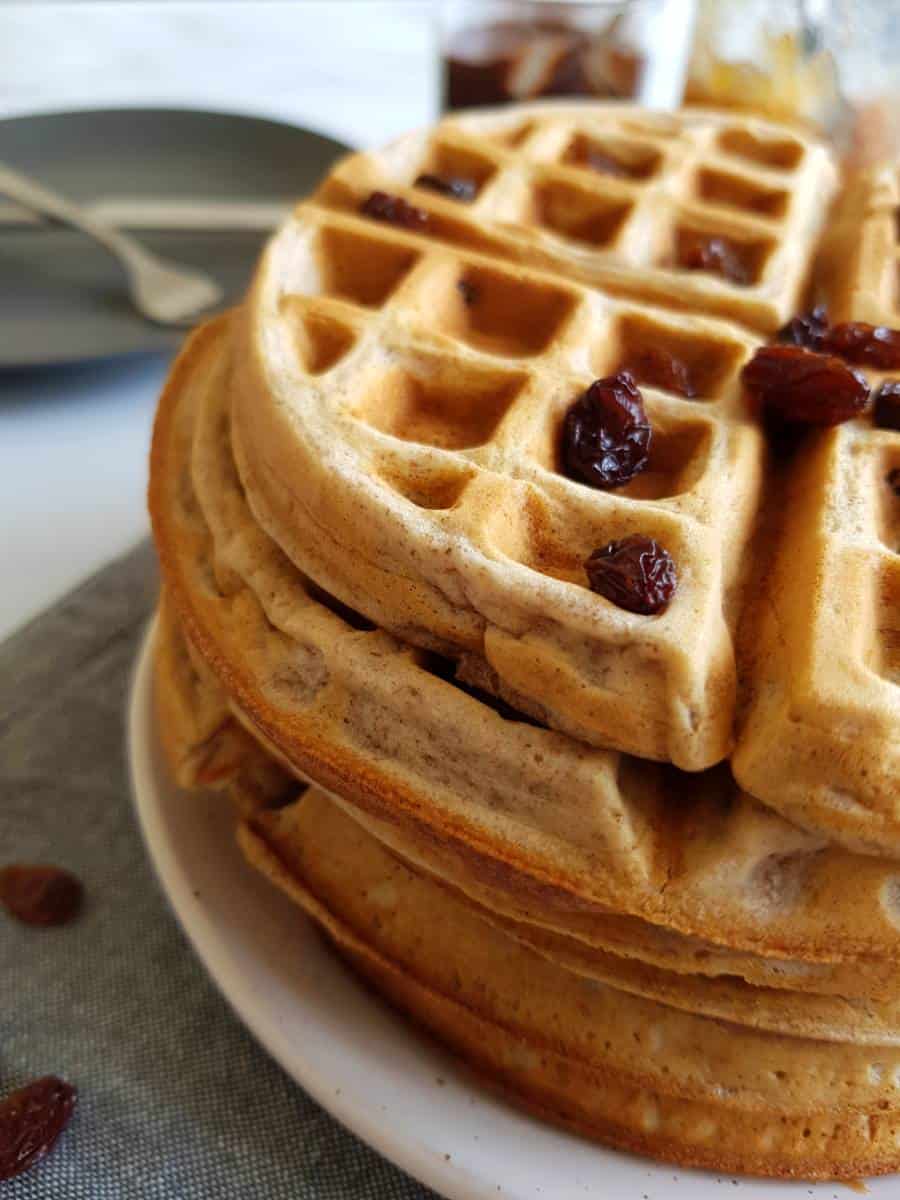 Cinnamon raisin waffle stack topped with raisins.