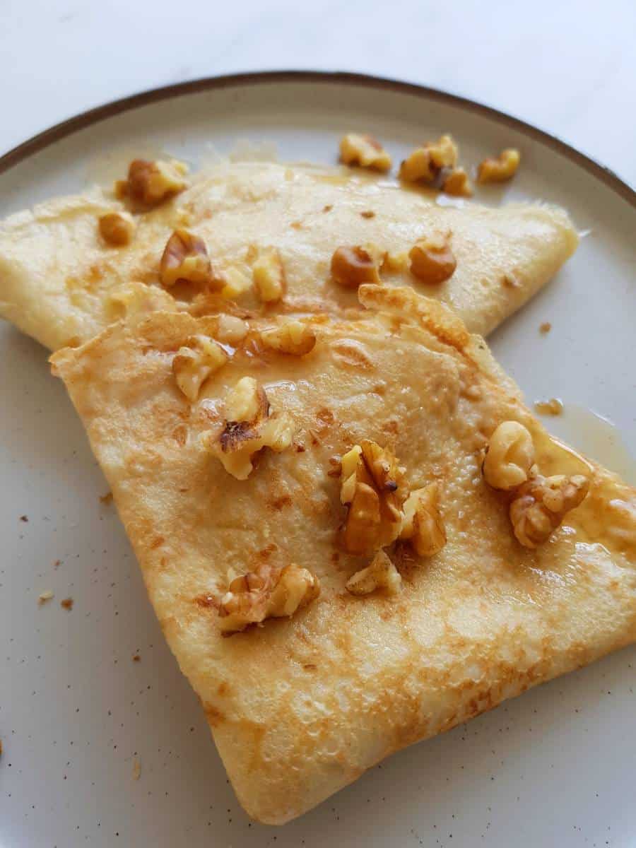 Crepes with almond milk on a plate.