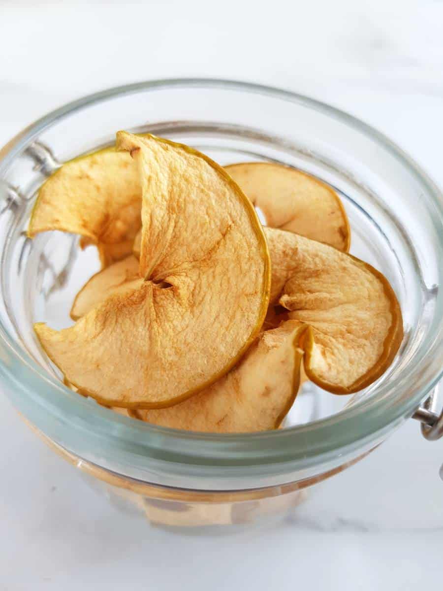 Dried apple chips in a jar.