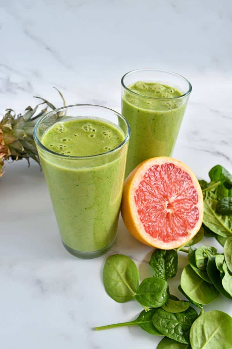 Grapefruit spinach smoothie in glasses.