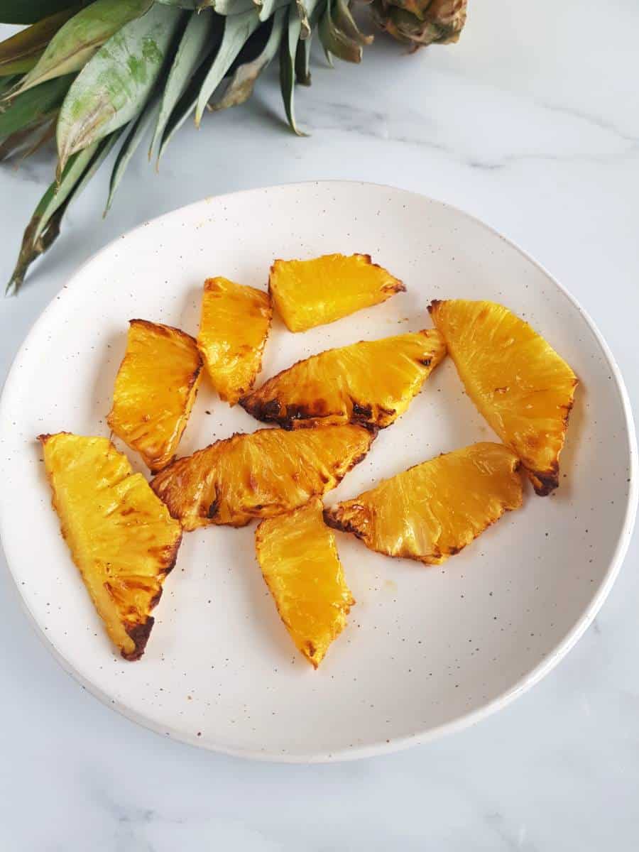 Grilled pineapple on a plate.