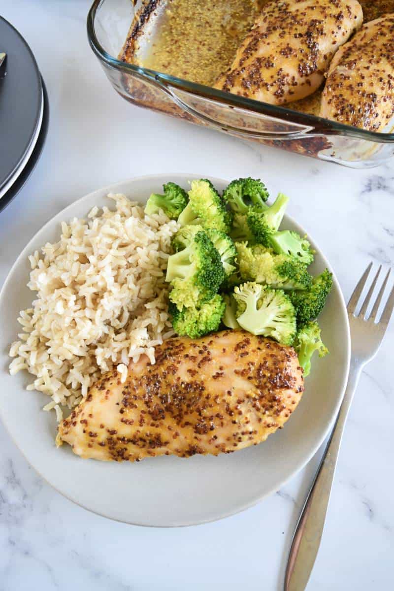 Honey mustard chicken with rice and broccoli on a plate.