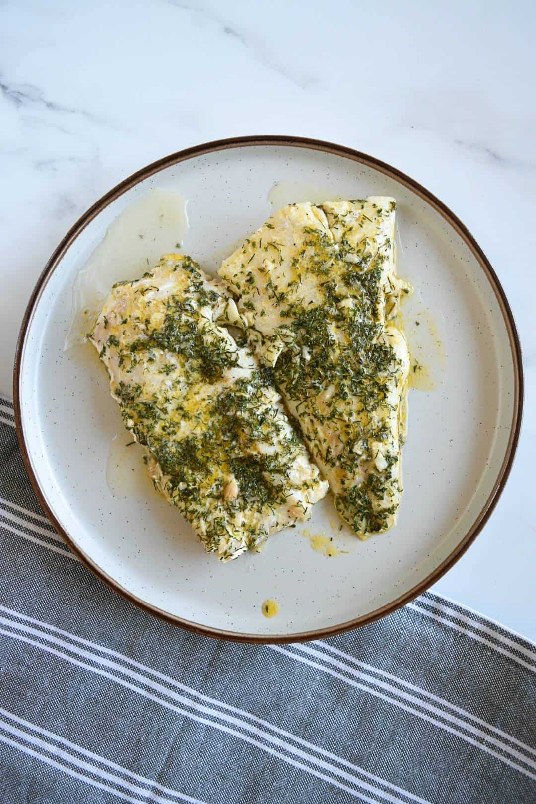 Lemon butter cod on a plate.
