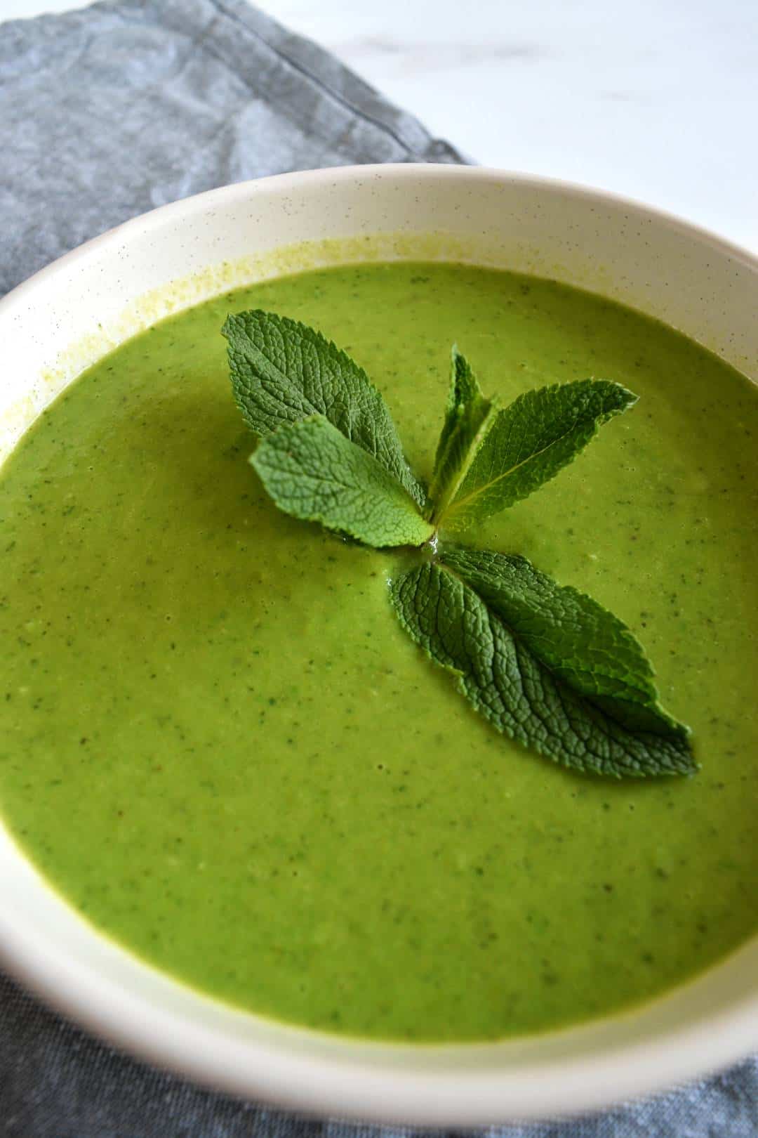 Mint and pea soup with mint garnish.