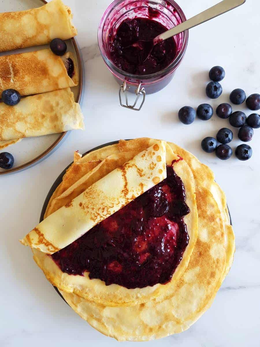 Blueberry jam spread on Norwegian pancakes.