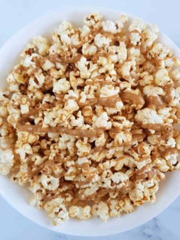 Peanut butter popcorn in a white bowl.