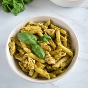 Pesto pasta with chicken and fresh basil.