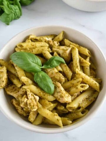 Pesto pasta with chicken and fresh basil.