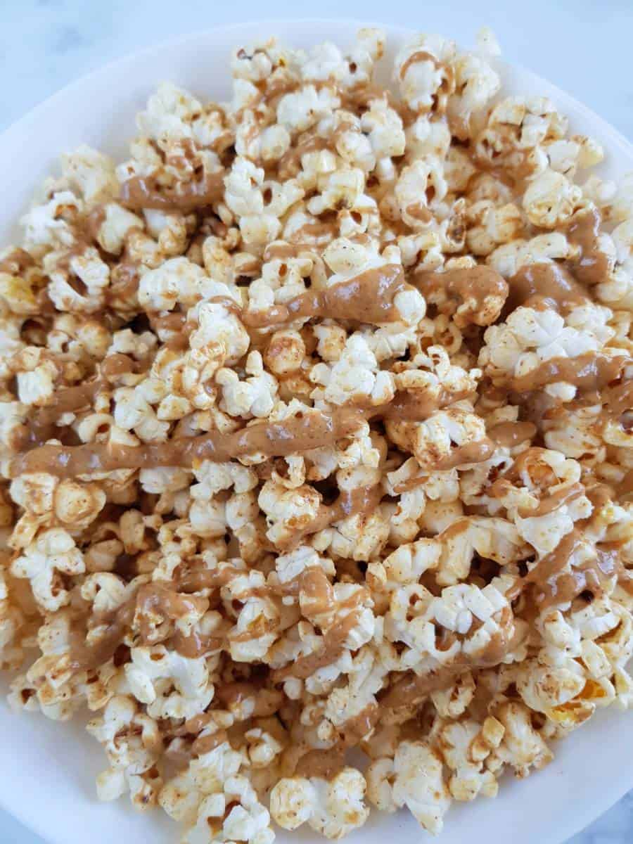 Popcorn with peanut butter drizzled on top.