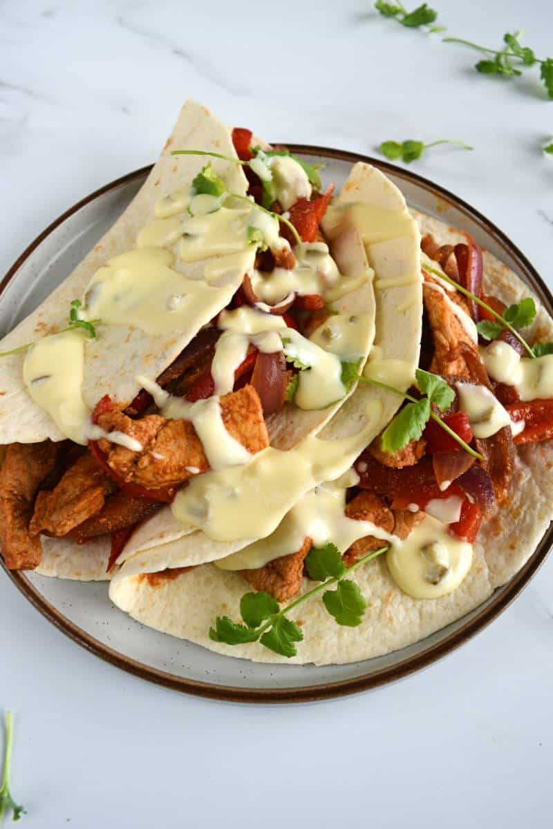 Pork chop fajitas with cheese sauce.