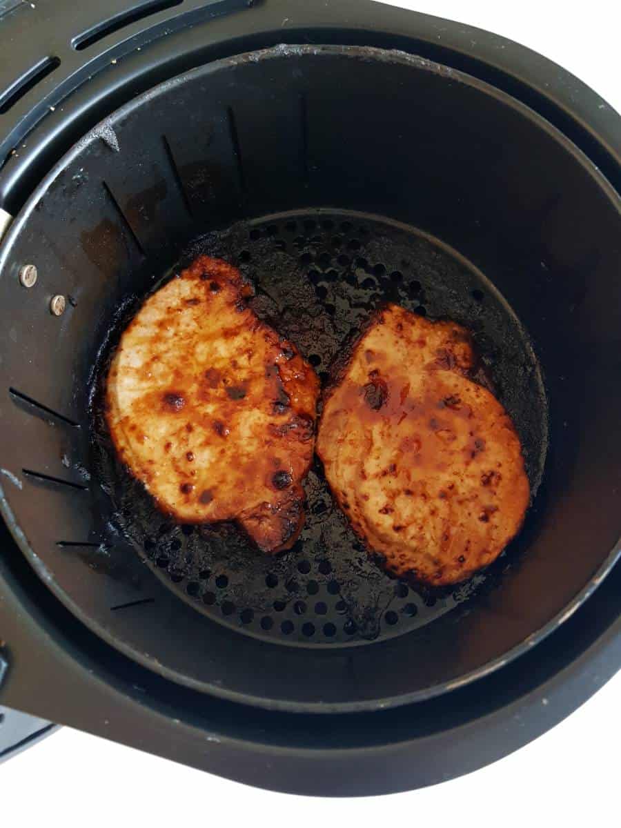 Pork chops in an air fryer.