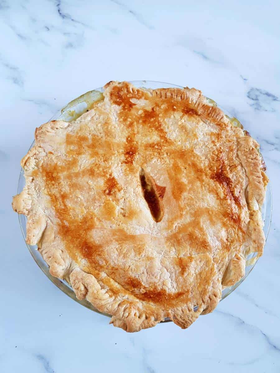 Puff pastry chicken pot pie on a marble table.