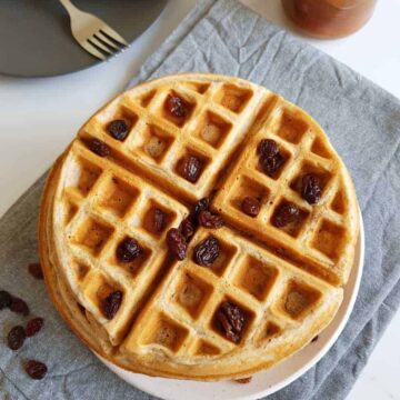 Stacked waffles on a plate.