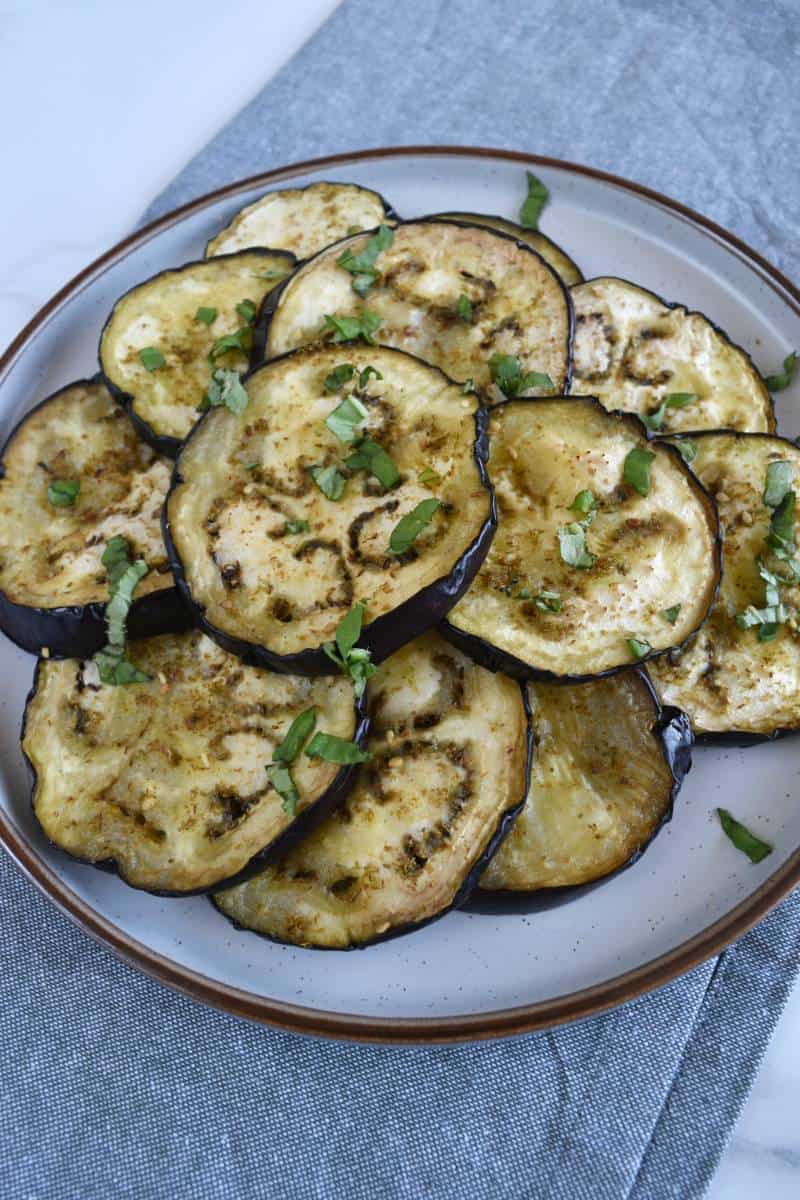 Roasted eggplant slices on a plate.