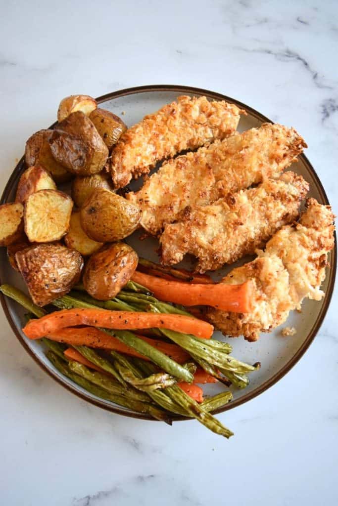 Roasted vegetables and chicken on a plate.
