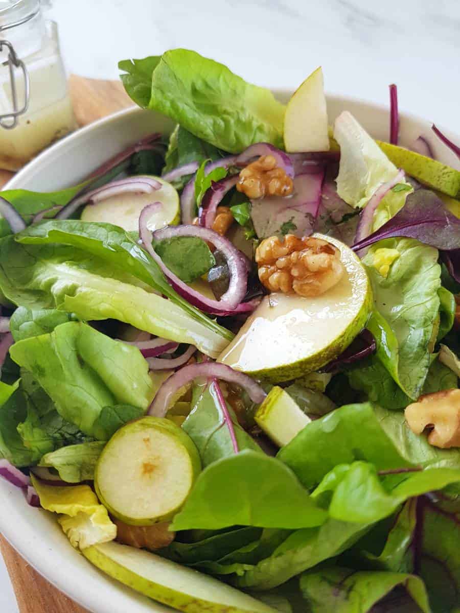 Salad with pears and walnuts in a bowl.