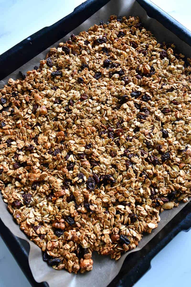 Granola spread out over a sheet pan.