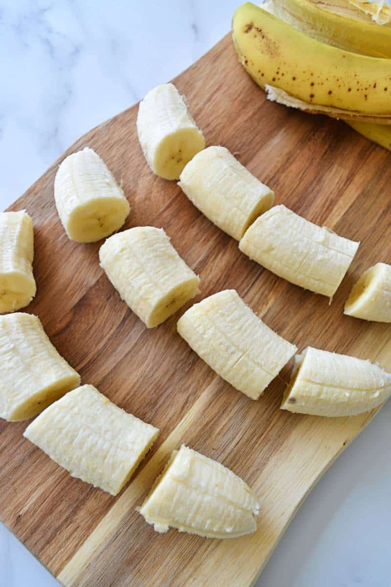 Sliced bananas on a chopping board.