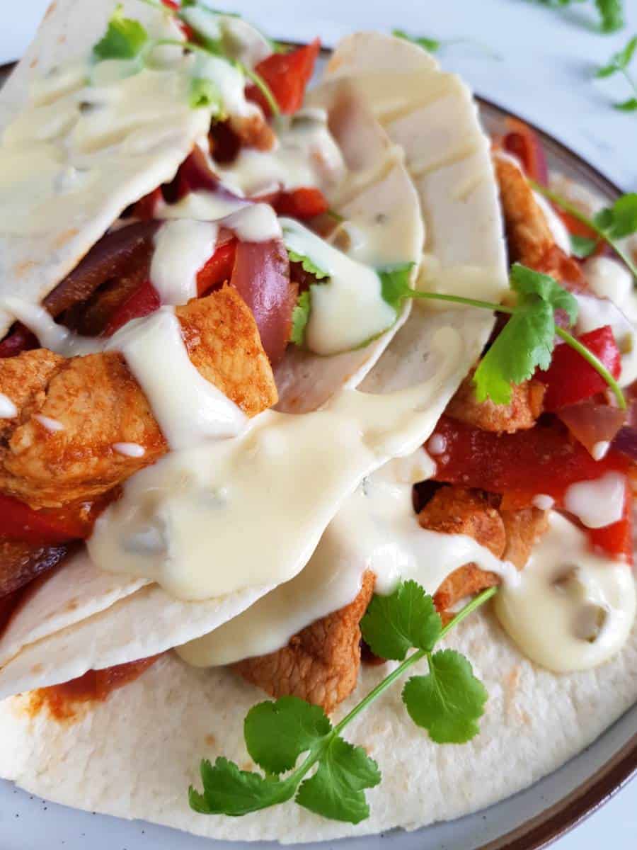 Tex mex sour cream sauce on pork fajitas.