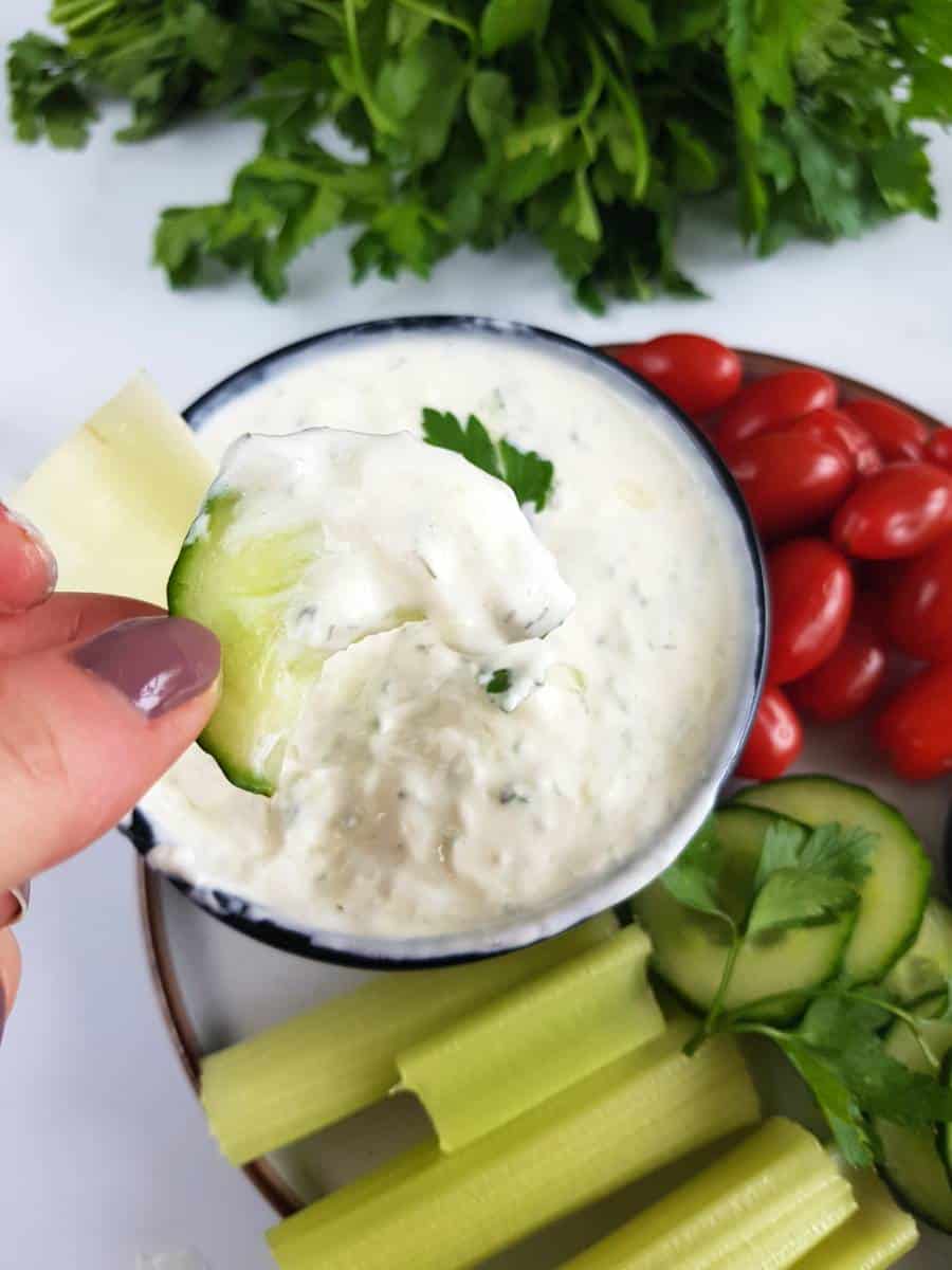 Cucumber slice dipped in Tzatziki.