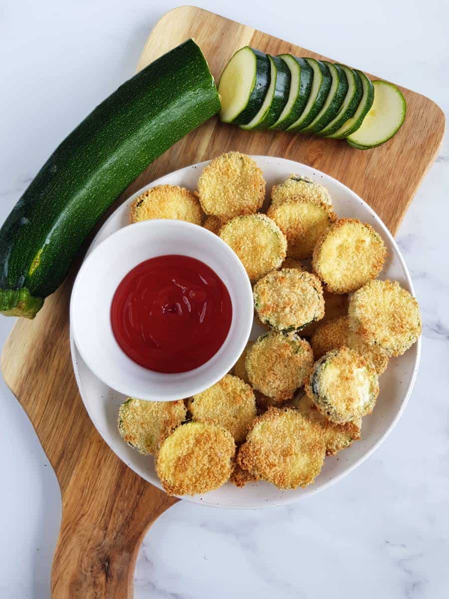 Air fryer zucchini chips on a chopping board.