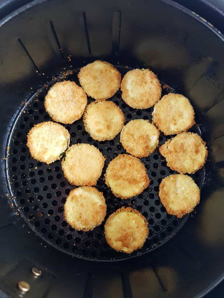 Zucchini slices in an air fryer.