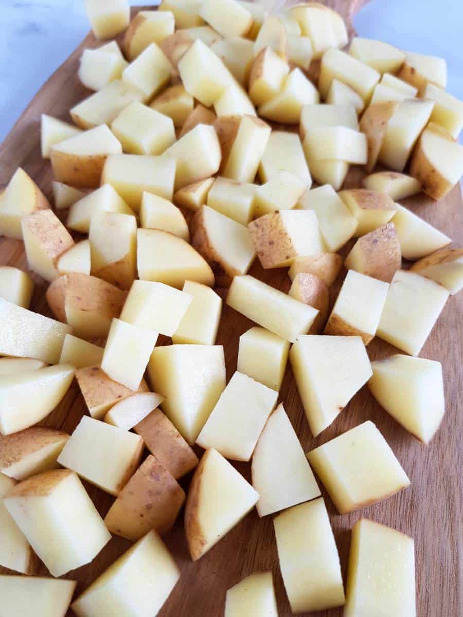 Diced potatoes on a chopping board.