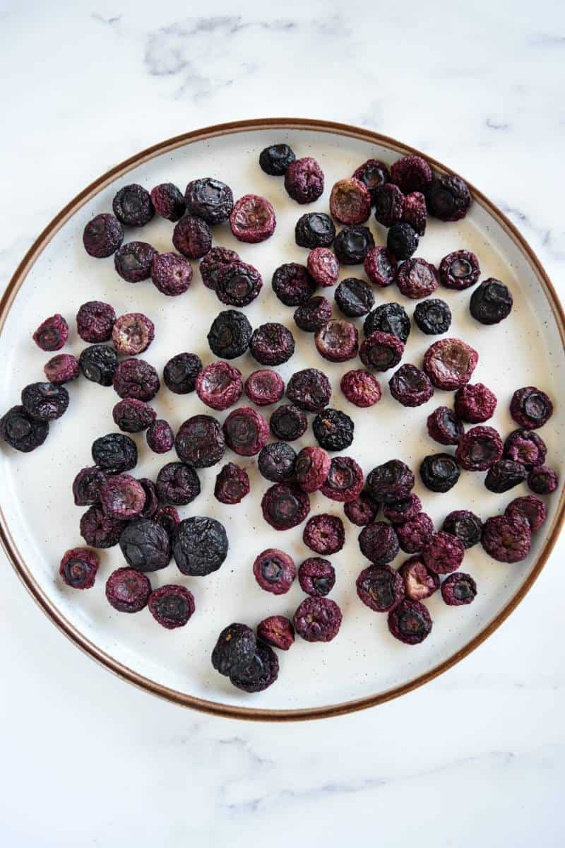 Dried blueberries on a plate.