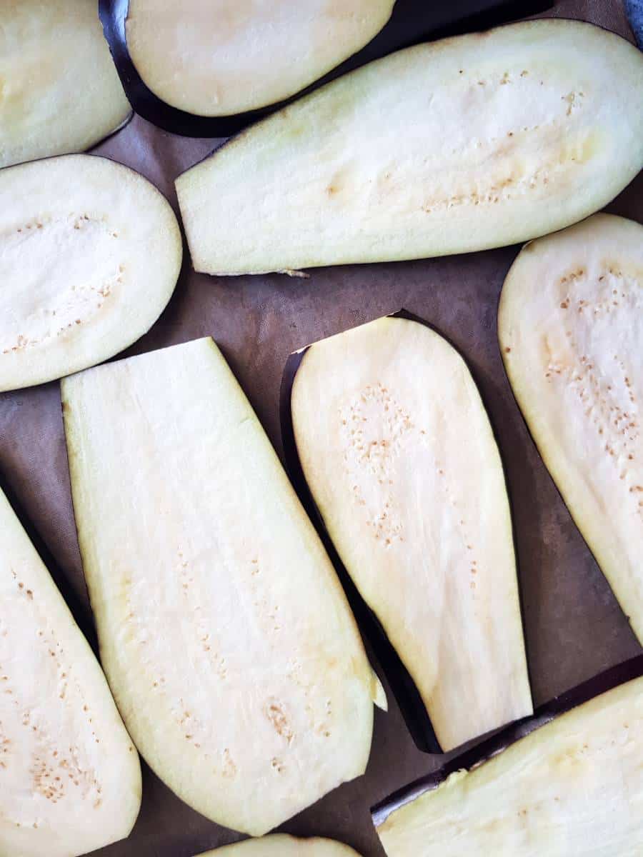 Eggplant slices on a baking tray.