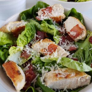 Keto caesar salad with bacon and chicken.