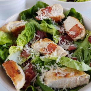 Keto caesar salad with bacon and chicken.