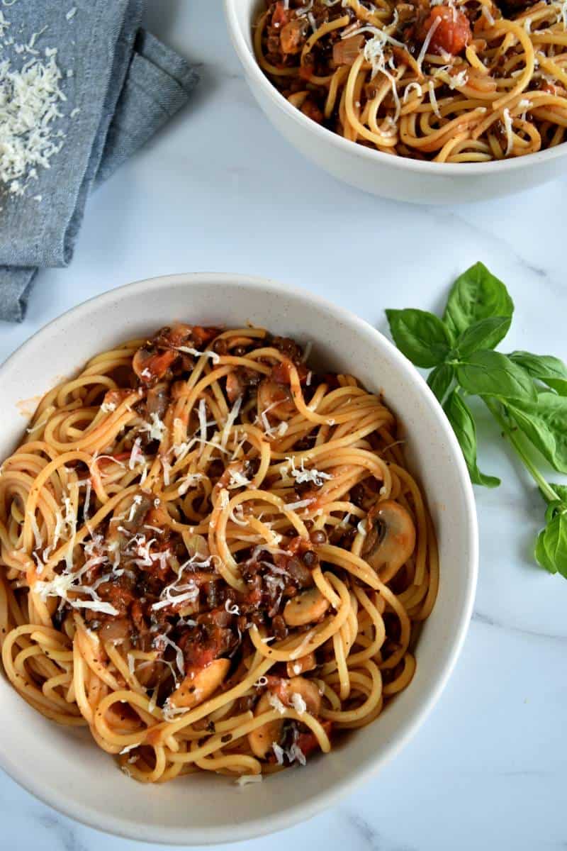 Lentil and mushroom bolognese in pasta bowls.