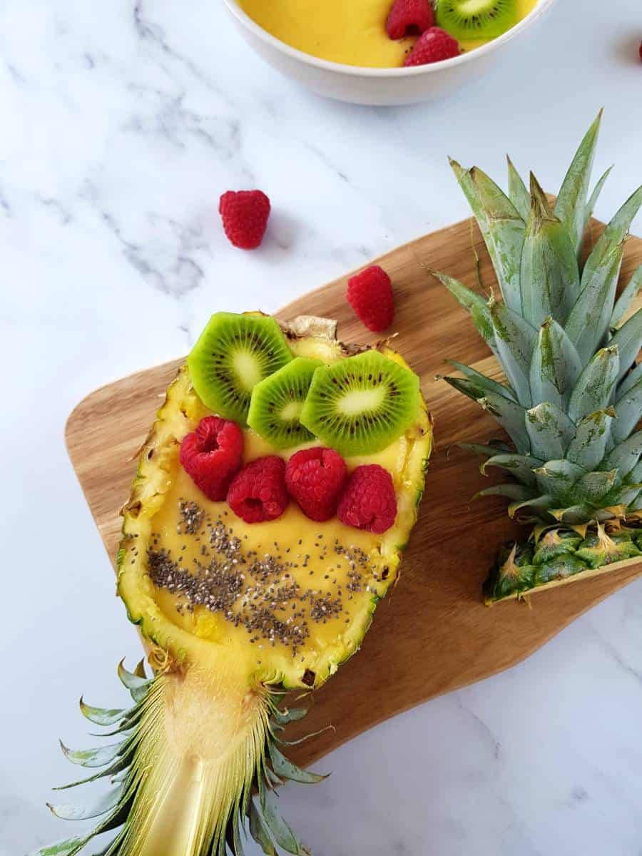 Mango pineapple smoothie bowl in a hollow pineapple.