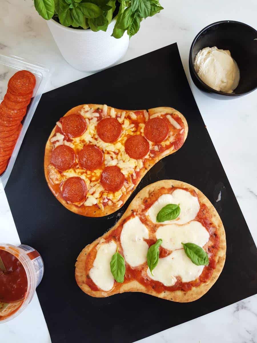 Naan pizzas on a table.