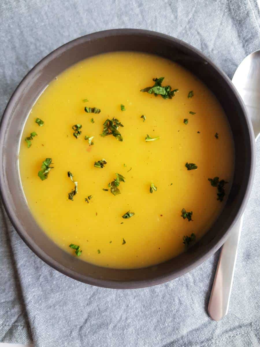 Potato and carrot soup in bowl.