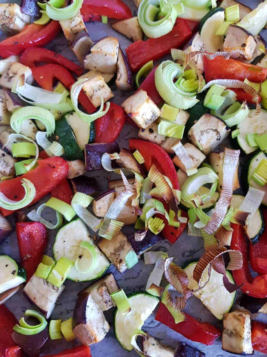 Roasted vegetables on a baking sheet.