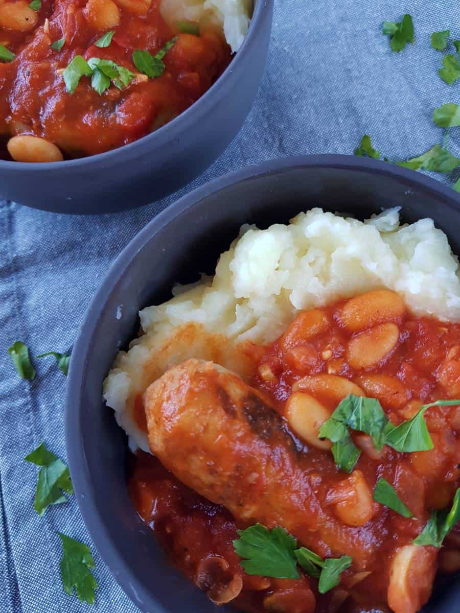 Sausage stew with white beans in bowl.