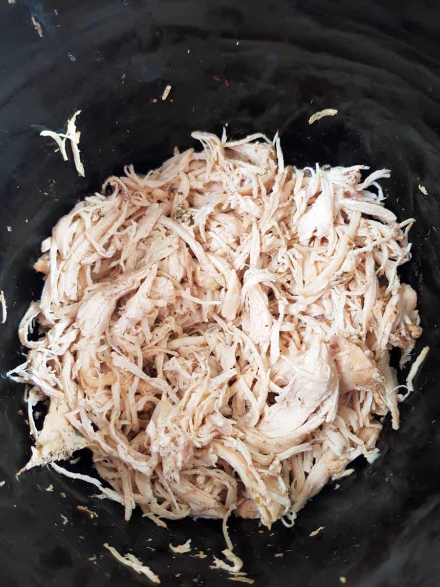 Shredded chicken in slow cooker.