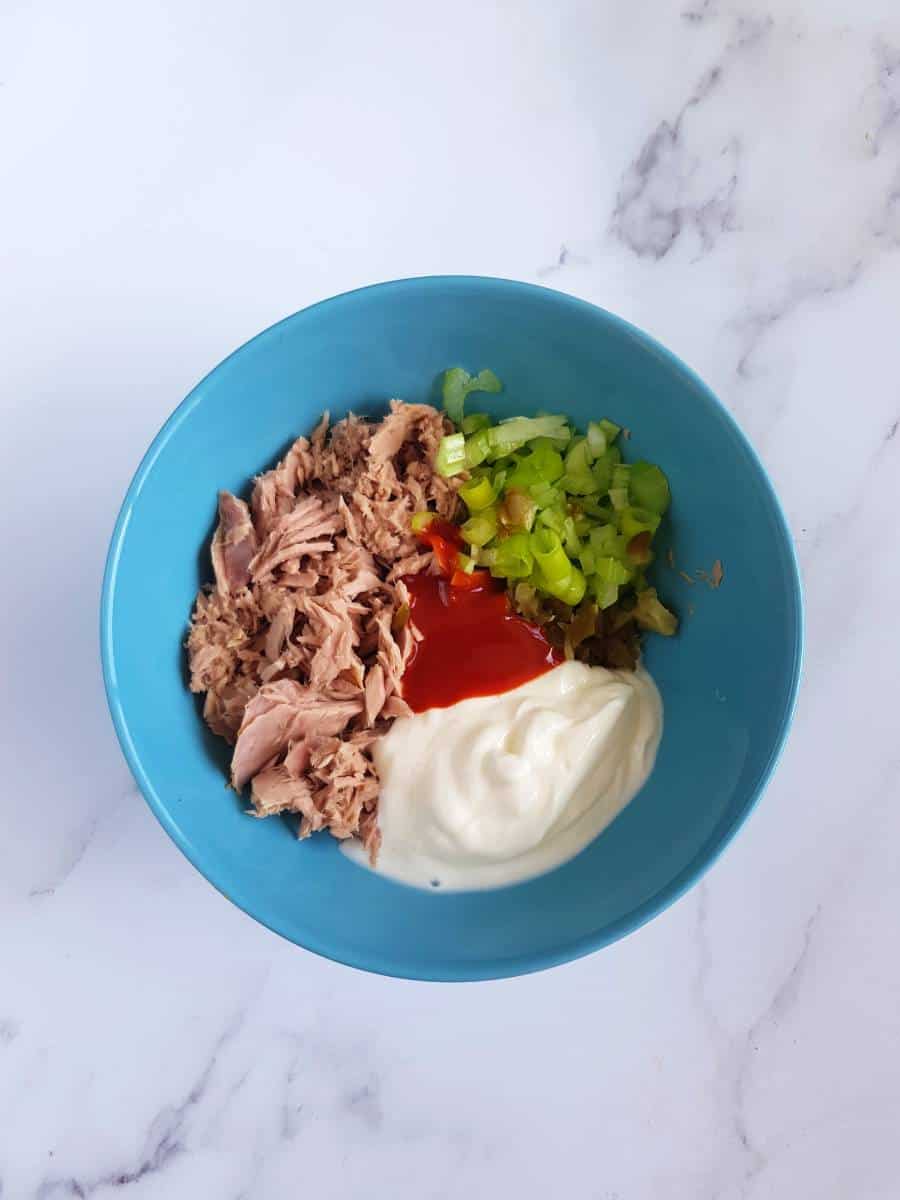 Tuna salad ingredients in bowl.