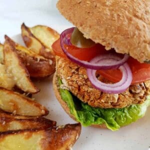 Vegan pinto bean burgers with wedges.