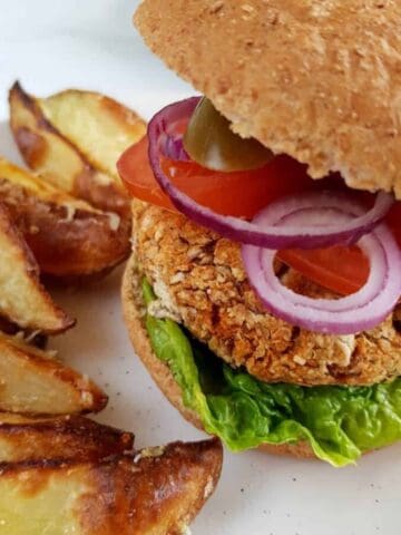 Vegan pinto bean burgers with wedges.