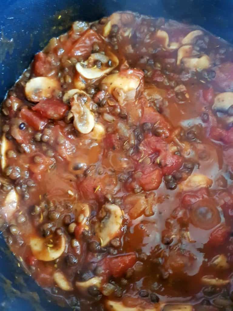 bolognese sauce cooking in a pot.