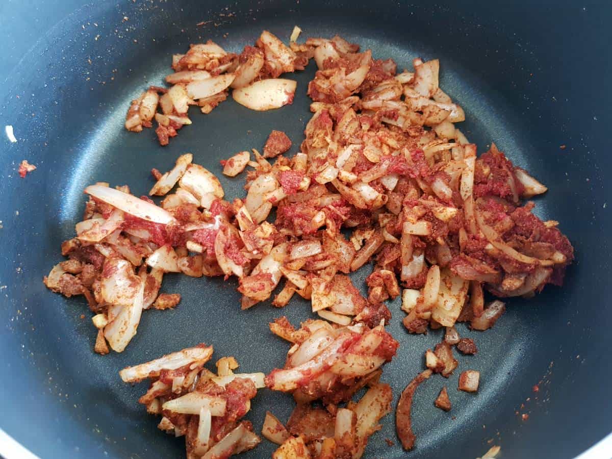 onion and spices sauteeing in a pot.